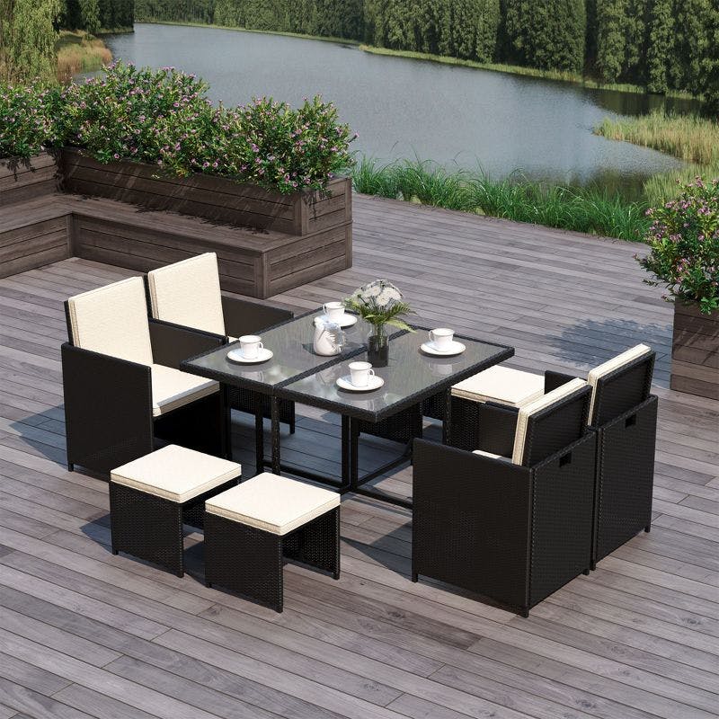 Compact 9-Piece Black Wicker Outdoor Dining Set with Cream Cushions